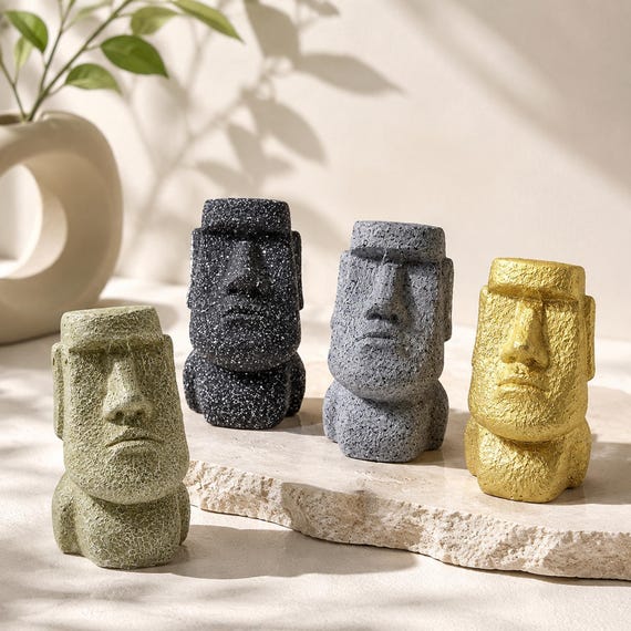 A stoic Easter Island Moai head that holds your glasses — deadpan desk guardian energy that's impossible not to smile at.