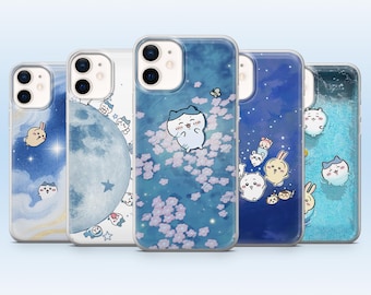 May include: Five clear smartphone cases featuring various cartoon character illustrations. Designs include a blue moon, pink cherry blossoms, starry night skies, and light blue water patterns with small white and tan creatures floating throughout.