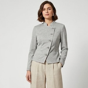 May include: A light gray long-sleeve jacket with a mandarin collar and an asymmetrical front closure featuring five round buttons. The jacket is paired with beige wide-leg trousers that have a visible front pleat and a structured waistband.