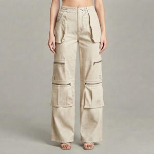 May include: Beige high-waisted cargo trousers featuring a wide-leg silhouette, two front pockets, and two large cargo pockets on each leg. Each cargo pocket is secured with a horizontal zip closure. The trousers have a button and zip fly front.