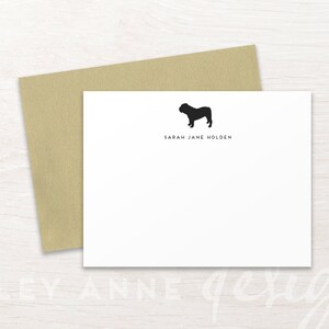 May include: A white card with a black silhouette of a bulldog and the text "Sarah Jane Holden" printed on it.