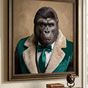 May include: A framed portrait of a gorilla wearing a white dress shirt, a dark green tie, and a green velvet vest with a tan faux fur collar. The gorilla has dark fur and brown eyes, set against a muted tan background within a dark ornate frame.