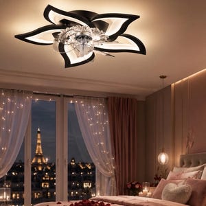 May include: A black and white flower-shaped ceiling light fixture with integrated LED lighting and a central crystal-like accent. The fixture features five curved petals radiating from the centre, providing illumination to the room below.