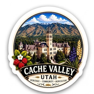 May include: A circular sticker featuring a large building with a central tower set against a mountain range under a blue sky. The text reads CACHE VALLEY UTAH HERITAGE COMMUNITY AGRICULTURE. Raspberries, white flowers, lavender, and wheat are depicted.