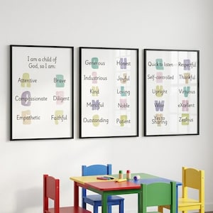 May include: Three framed wall posters with black frames featuring educational text and colorful abstract shapes. The prints list positive character traits like Attentive, Brave, Compassionate, Diligent, Empathetic, Faithful, Generous, Honest, and others.