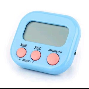 May include: A light blue digital kitchen timer with a rectangular LCD screen and three round pink buttons. The buttons are labeled MIN, SEC, and START/STOP, with the word RESET printed below the MIN and SEC buttons in black text.