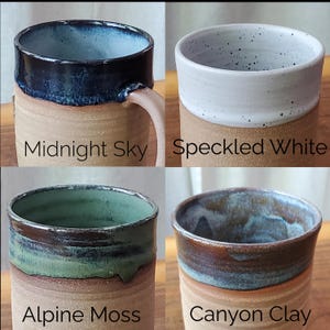 May include: Four handmade ceramic mugs with unique glaze finishes. The mugs are labeled "Midnight Sky" with a dark blue rim, "Speckled White", "Alpine Moss" with green and brown tones, and "Canyon Clay" with brown and blue hues.