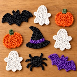 May include: A collection of nine crocheted Halloween-themed appliques including a black bat, a white ghost, an orange pumpkin, a second orange pumpkin, a black witch hat with a purple band, a second white ghost, a third white ghost, a black spider, and a purple bat.