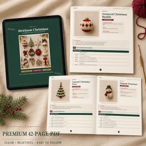 May include: A digital tablet displaying a green cover for a crochet pattern collection titled Heirloom Christmas, alongside an open printed booklet showing instructions for a Textured Christmas Bauble, a Layered Christmas Tree, and an Elegant Snowman.