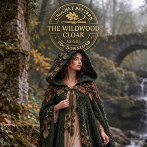 May include: A dark green crochet cloak featuring an attached hood and decorative brown and green leaf-shaped embellishments. The text reads: CROCHET PATTERN THE WILDWOOD CLOAK XS-5XL PDF DOWNLOAD. The cloak is fastened at the neck with a metal clasp.