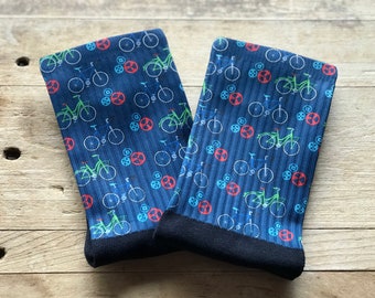 May include: A pair of blue socks with a pattern of green and white bicycles and red wheels.