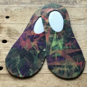 May include: A pair of no-show socks with a colorful abstract geometric pattern in shades of green, purple, orange, and brown.