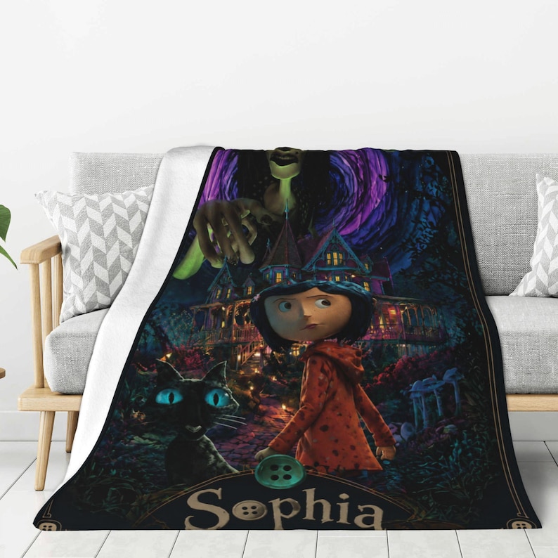 May include: A rectangular throw blanket featuring a dark, animated-style scene with a young character in a red jacket, a black cat with bright blue eyes, a large house, and a tall figure above. The name Sophia is printed in large letters.