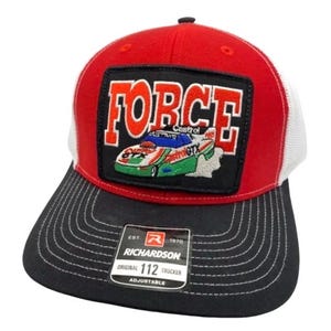 May include: A red, white, and black trucker hat featuring a rectangular patch on the front. The patch displays the word FORCE in orange letters above an embroidered race car with Castrol GTX branding. A Richardson 112 sticker is on the black brim.