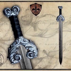 May include: A silver and black latex sword with a decorative handle. The sword has a fleur-de-lis design on the pommel and a black leather grip. The sword is handmade and has the words "Handmade" and "Fait a la main" on the handle.