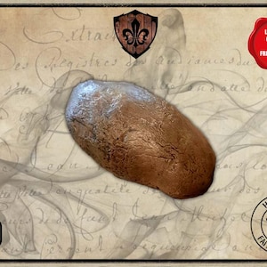 May include: A brown latex prop, possibly a tongue, with a textured surface. The prop is set against a vintage background with script writing and decorative elements. The image includes a "handmade" seal.