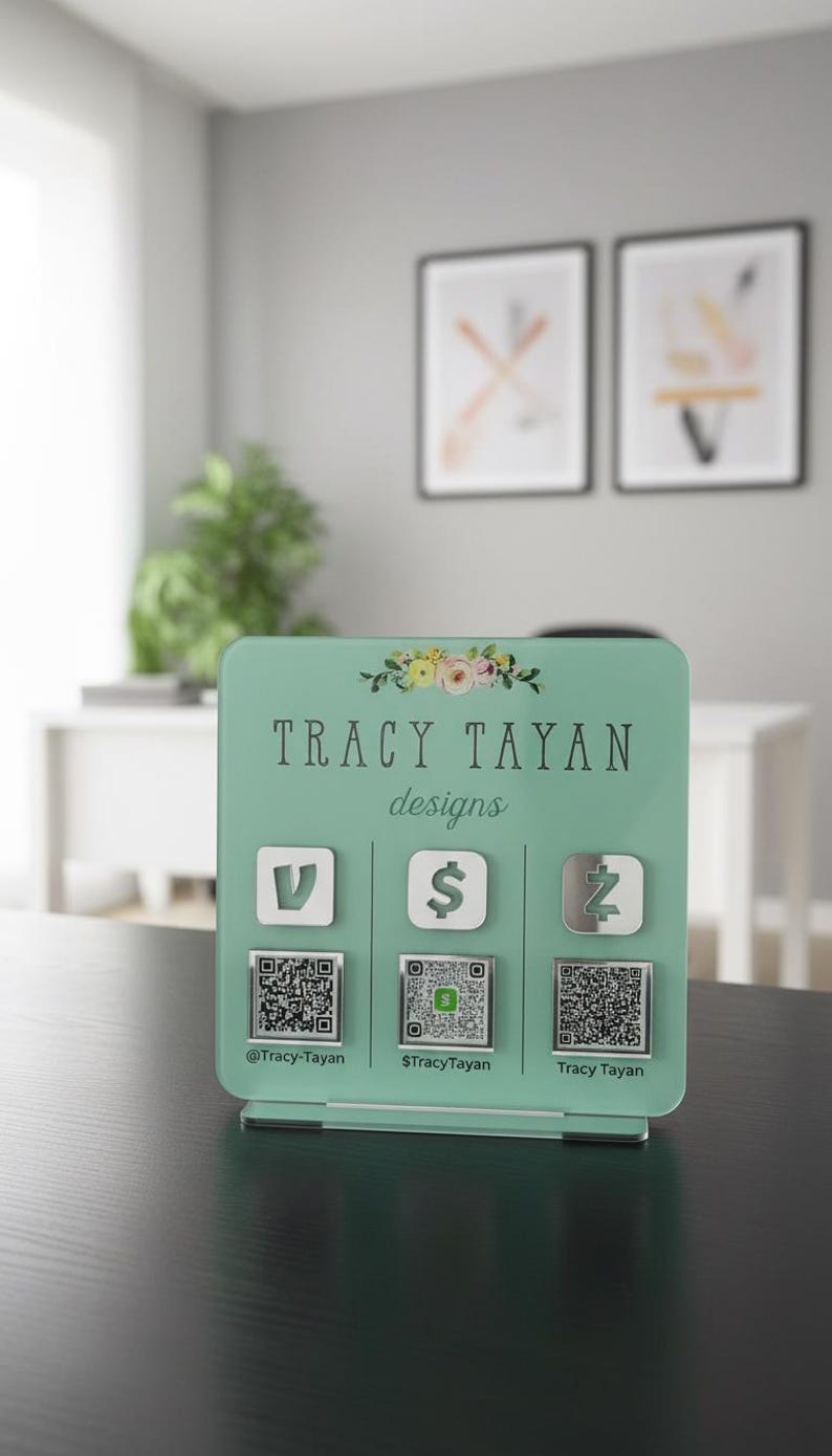 Custom acrylic QR code sign with three QR codes, gold social media icons and personalized business branding, displayed on a reflective countertop
