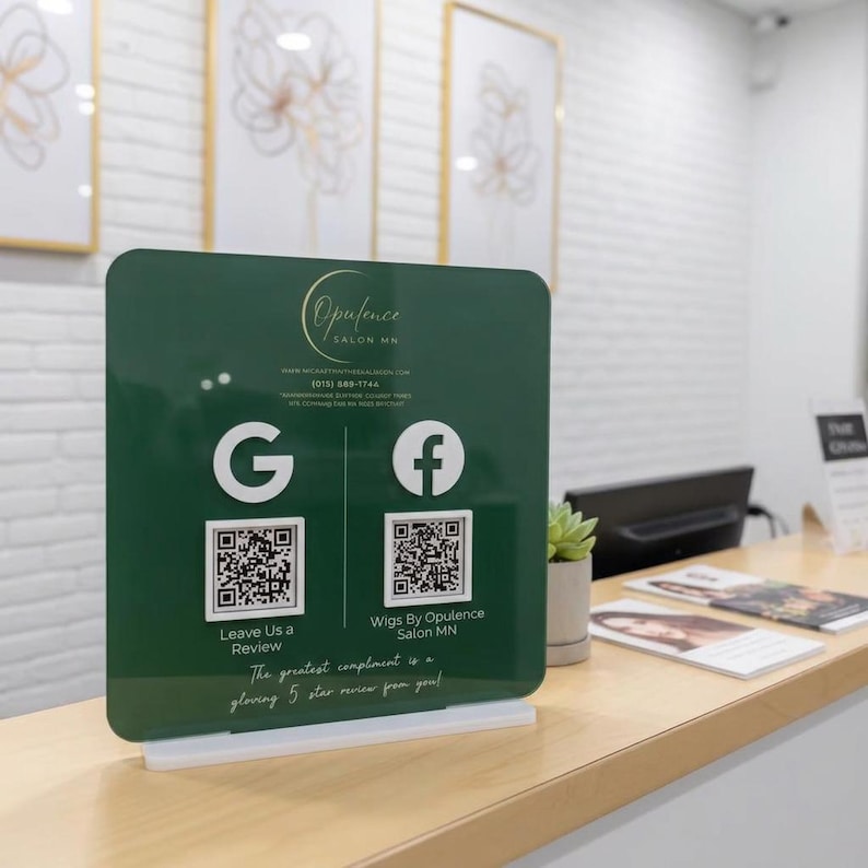 May include: A dark green square acrylic sign for Opulence Salon MN featuring white Google and Facebook logos, two QR codes, and text that reads Leave Us a Review and Wigs By Opulence Salon MN, all mounted on a white rectangular base.