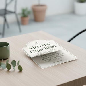 May include: A white paper document with dark green text titled Moving Checklist Printable. The text includes Relocation Planner, Home Organization, Minimalist Transition Guide, Moving House Planner, and Declutter Guide with small leaf icons.