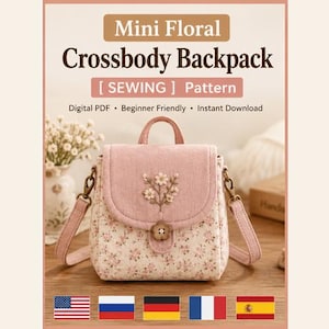 May include: A mini floral crossbody backpack sewing pattern featuring a pink flap with embroidered flowers, a flower-shaped button closure, and a floral print body. The text reads Mini Floral Crossbody Backpack [ SEWING ] Pattern.
