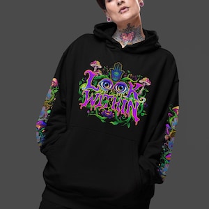 May include: A black hooded sweatshirt featuring a vibrant graphic on the chest and sleeves. The design includes the text "LOOK WITHIN" in purple, surrounded by colorful illustrations of eyes, mushrooms, lotus flowers, and hamsa hand symbols.