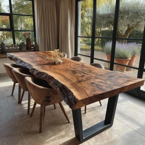 May include: A large rectangular dining table featuring a natural live edge wood slab top with visible grain patterns and dark knots, supported by two thick black metal U-shaped legs, accompanied by several matching curved wooden dining chairs.