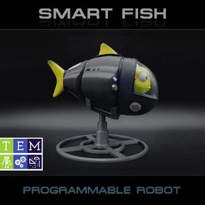 Peut inclure: Un jouet robot poisson noir et jaune avec un cockpit à dôme transparent contenant une figurine de poisson jaune. Le robot est monté sur un support circulaire gris. Le texte SMART FISH et PROGRAMMABLE ROBOT apparaît avec un logo STEM coloré.