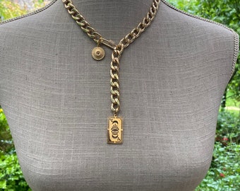 Curb chain tie necklace with large links, rhinestone clasp and golden charms “Lucky charm!”
