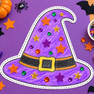 May include: A purple paper witch hat cutout decorated with orange, purple, and gold glitter star stickers, colorful plastic gems, and a black band with a yellow buckle. The hat is colored with purple crayon and has a white dashed border.