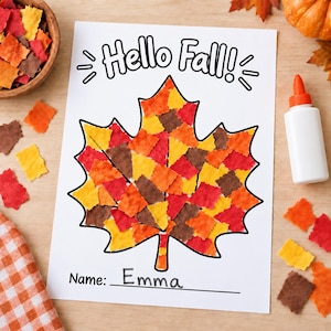 May include: A white paper craft sheet featuring the text Hello Fall! at the top and a large maple leaf outline filled with small, square-cut pieces of red, orange, yellow, and brown paper. The bottom includes a line for a name, written as Emma.