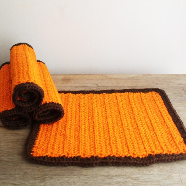 4 handmade orange crochet placemats with brown trim