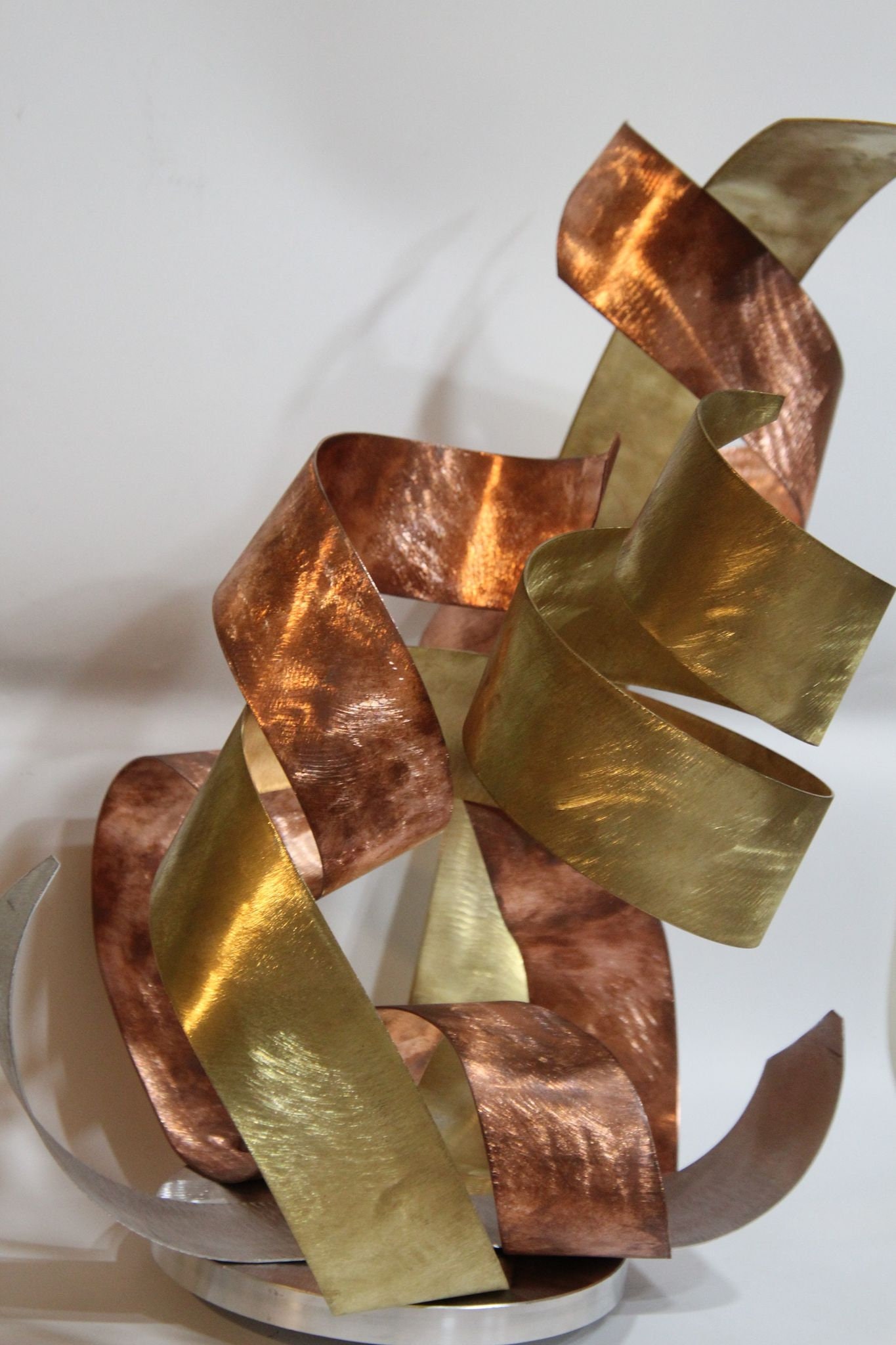 gold metal ribbon wall art sculpture