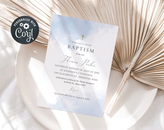 May include: A baptism invitation card with a watercolor blue background. The card includes the text "Please join us for the BAPTISM of our son" and details for the event, including the date, time, and location. The card is on a white plate.