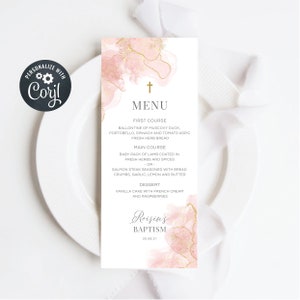May include: A pink and gold baptism menu with a cross at the top. The menu lists the first course, main course, and dessert. The text at the bottom reads "Roisin's Baptism 30.08.21".