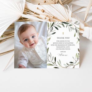 May include: A thank you card with a green leafy border and a photo of a baby boy. The text reads "Thank you for adding to the joyous spirit of my baptism with the blessings of your love. Thoughtful gifts and prayers for me. With love, Thomas."