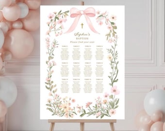 May include: A white floral seating chart with a pink bow and the text "Sophia's Baptism Please find your seat".