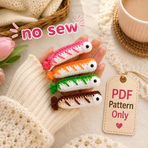 May include: Four small crocheted shrimp figures in pink, orange, green, and brown, each with a black eye and white underside. The image includes the text "no sew" and a tag labeled "PDF Pattern Only" with a small red heart icon.