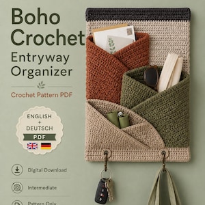 May include: A crochet wall organizer featuring a dark gray top border, a beige main panel, and three overlapping pockets in rust, olive green, and light beige. The organizer includes two metal hooks at the bottom holding keys and a fabric strap.