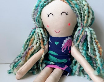Cloth Doll with Thick Blue Colorful Hair, Light Skin, and a Dinosaur Print Dress with Matching Removable Skirt