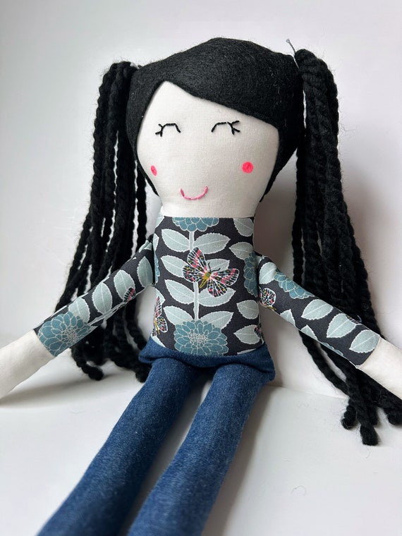 Cloth Doll with Black Hair, Light Skin, and a Butterfly Patterned Top and Blue Jeans