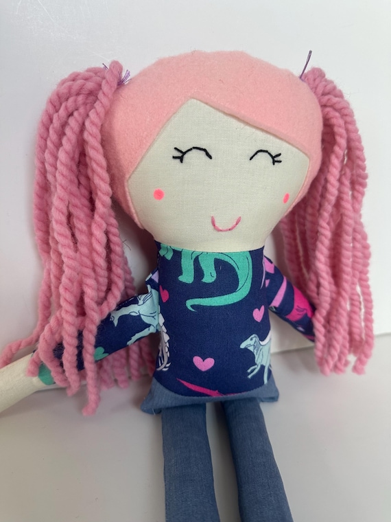 Cloth Doll with Pink Hair, Light Skin, and a Cute Dinosaur Patterned Top and Jeans