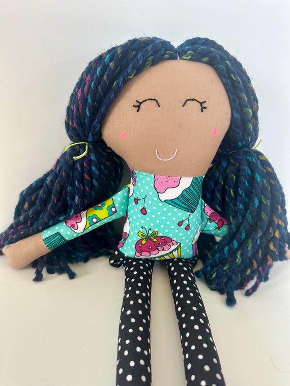 Cloth Doll with Thick Blue Yarn Hair, Tan Skin, and a Cute Cupcake Patterned Top and Polka Dot Pants