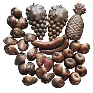 May include: A collection of decorative fruit wall plaques made of bronze-toned metal. The set includes multiple strawberries, two clusters of grapes, a pineapple, a pair of bananas, and several round fruits, all featuring textured surfaces.