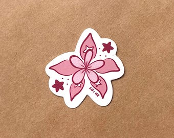 May include: A die-cut sticker featuring a stylized pink flower with five large petals and a smaller five-petaled center. The design includes two dark pink stars, small dots, and the text 10:42 printed in a dark pink font on one petal.