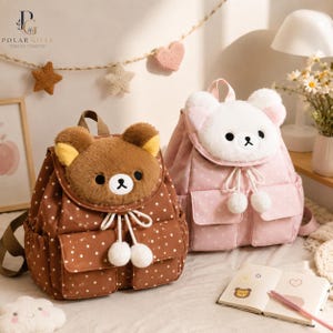 May include: Two plush backpacks featuring bear faces on the front flaps. The brown backpack has white polka dots and a brown bear face, while the pink backpack has white polka dots and a white bear face. Both include drawstring closures with pom-poms.