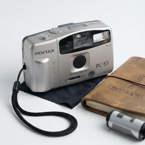 Cámara compacta de película PENTAX PC-55 de 35 mm con enfoque automático y estuche (China)