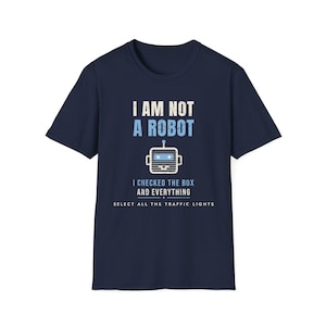 May include: A navy blue short-sleeve t-shirt featuring a graphic print with the text I AM NOT A ROBOT, I CHECKED THE BOX AND EVERYTHING, and SELECT ALL THE TRAFFIC LIGHTS, along with a stylized white and light blue robot head icon.