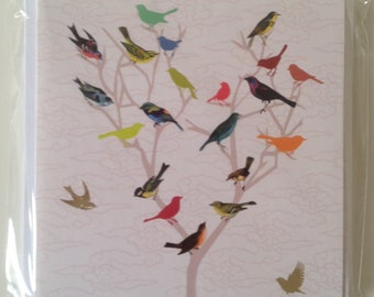 May include: A greeting card with a colorful illustration of a tree with many birds perched on its branches. The birds are in various colors, including red, blue, green, yellow, and orange.