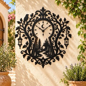 May include: A black wall clock shaped like a keyhole, featuring a central clock face with a crescent moon icon. The design includes intricate cutouts of a forest, a castle, a bird, and two hanging lanterns, all surrounded by leafy branches.