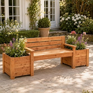 May include: A wooden garden bench featuring a slatted backrest and seat, flanked by two integrated square planters on either side. The natural wood grain is visible throughout the structure, which holds colourful purple and white flowering plants.